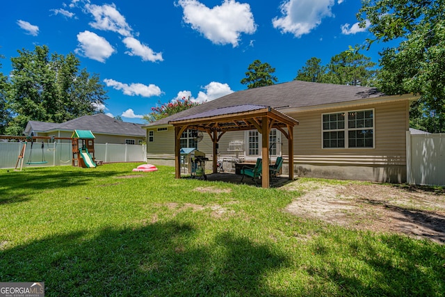 231 Brookstone Ct, Rincon, GA 31326 - rear view of house with a gazebo, a playground, a fenced backyard, and a patio area
