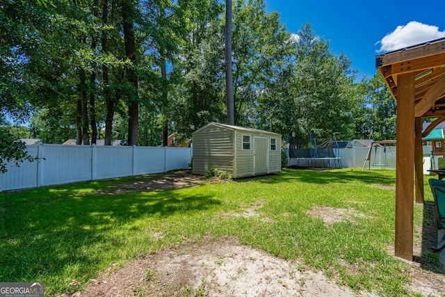 231 Brookstone Ct, Rincon, GA 31326 - fenced backyard featuring a trampoline, a storage unit, and a playground