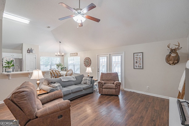 231 Brookstone Ct, Rincon, GA 31326 - living area with dark wood-style flooring, lofted ceiling, a ceiling fan, and a chandelier