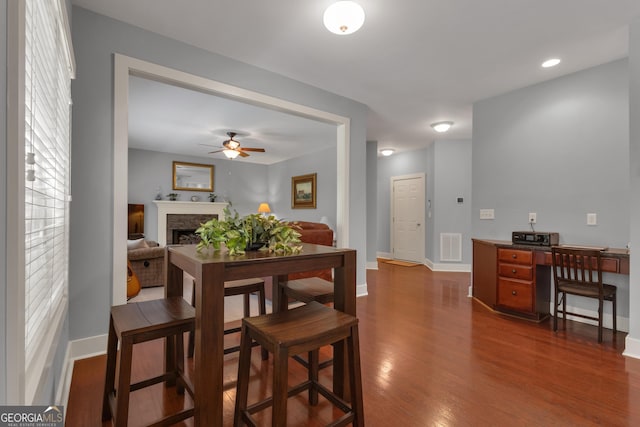 14 Hammock Ridge Dr, Newnan, GA 30265 - dining room with ceiling fan, dark wood-style flooring, a fireplace, and an office area
