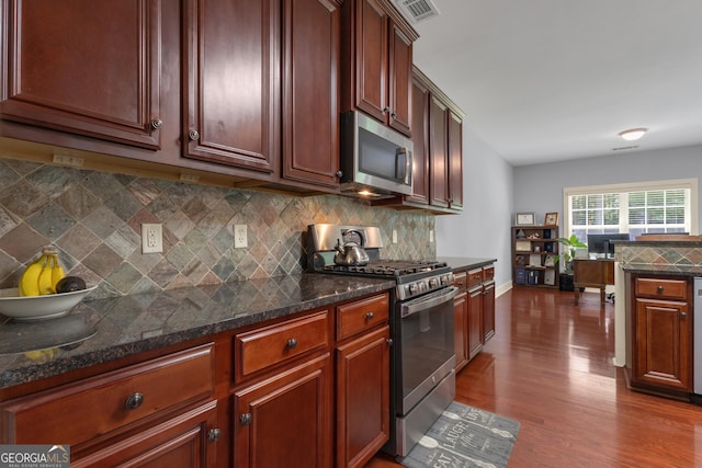 14 Hammock Ridge Dr, Newnan, GA 30265 - kitchen with stainless steel appliances, backsplash, dark wood finished floors, and dark stone counters