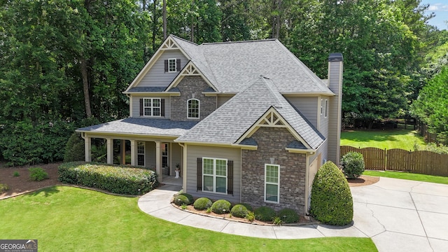 14 Hammock Ridge Dr, Newnan, GA 30265 - view of front facade featuring a shingled roof, stone siding, a chimney, concrete driveway, and a gate