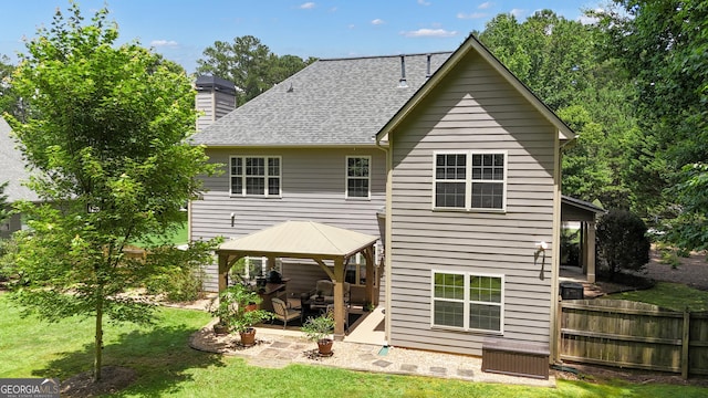 14 Hammock Ridge Dr, Newnan, GA 30265 - rear view of house with a gazebo, a patio, a chimney, and a shingled roof