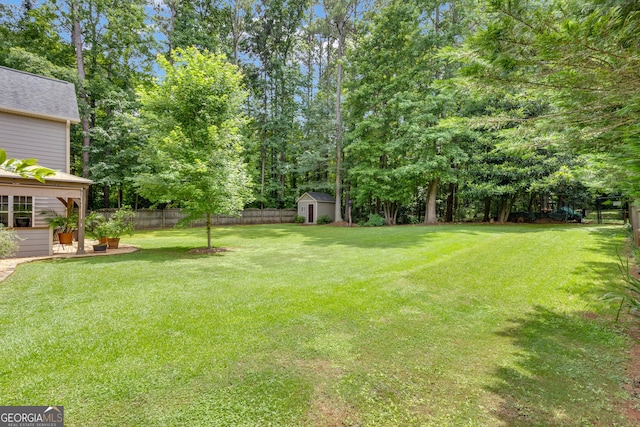 14 Hammock Ridge Dr, Newnan, GA 30265 - fenced backyard featuring a storage shed and view of scattered trees