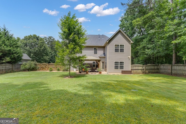 14 Hammock Ridge Dr, Newnan, GA 30265 - back of house with a fenced backyard, a patio area, and a shingled roof