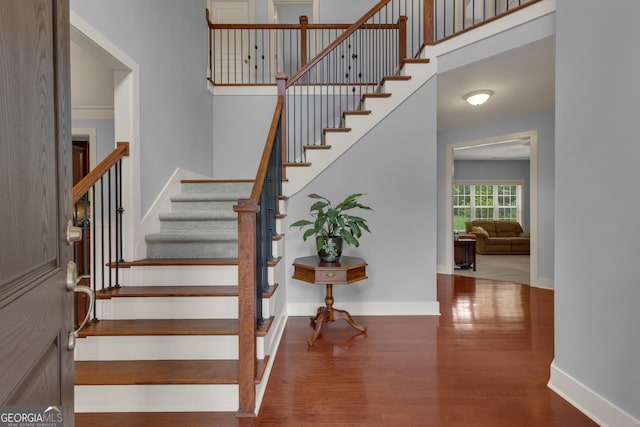 14 Hammock Ridge Dr, Newnan, GA 30265 - stairs with wood finished floors and a towering ceiling