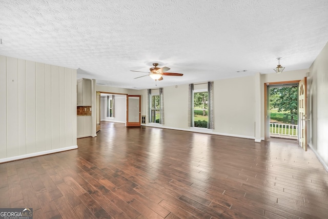 234 Crumbley Rd, Mcdonough, GA 30252 - unfurnished living room featuring dark wood finished floors, a textured ceiling, and ceiling fan