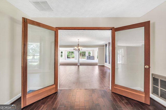 234 Crumbley Rd, Mcdonough, GA 30252 - hallway with a chandelier and dark wood-style floors
