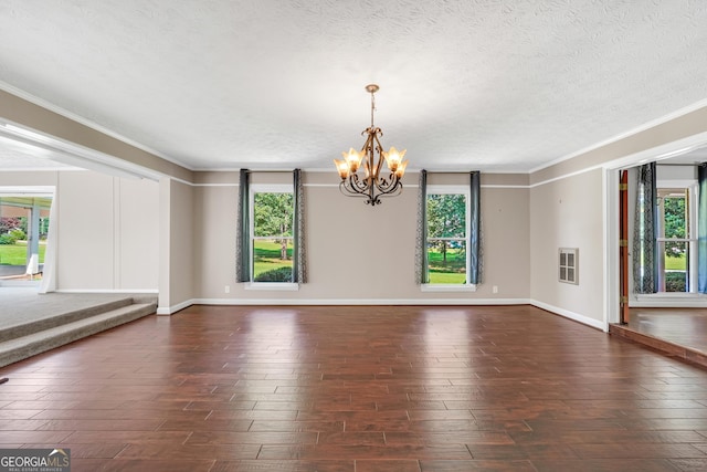 234 Crumbley Rd, Mcdonough, GA 30252 - empty room with crown molding, a chandelier, a textured ceiling, and dark wood finished floors