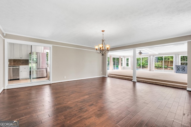 234 Crumbley Rd, Mcdonough, GA 30252 - unfurnished living room featuring a chandelier, dark wood-style flooring, a ceiling fan, and ornamental molding