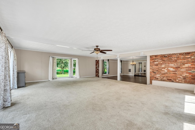 234 Crumbley Rd, Mcdonough, GA 30252 - unfurnished living room with a ceiling fan, a chandelier, carpet, and brick wall
