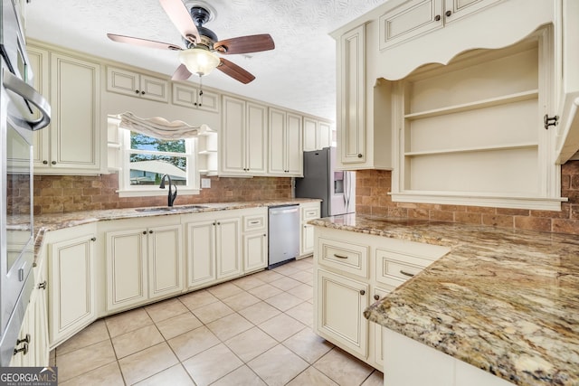 234 Crumbley Rd, Mcdonough, GA 30252 - kitchen with cream cabinets, stainless steel appliances, open shelves, ceiling fan, and a textured ceiling