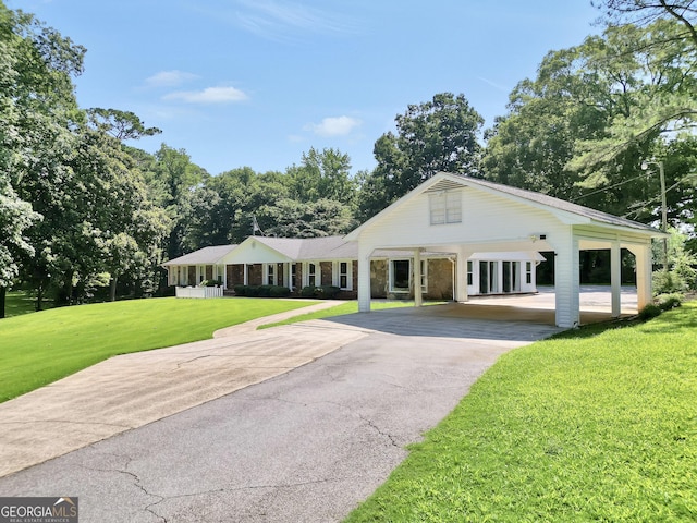 234 Crumbley Rd, Mcdonough, GA 30252 - view of front of home featuring asphalt driveway, a front yard, and a carport