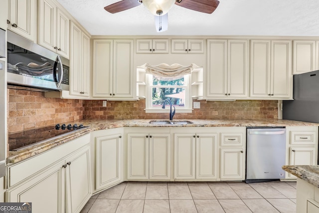 234 Crumbley Rd, Mcdonough, GA 30252 - kitchen with cream cabinets, stainless steel appliances, ceiling fan, and backsplash