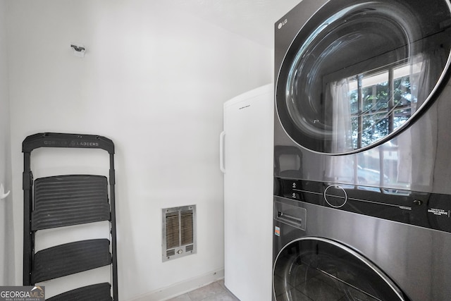 234 Crumbley Rd, Mcdonough, GA 30252 - laundry room with stacked washing machine and dryer and tile patterned flooring