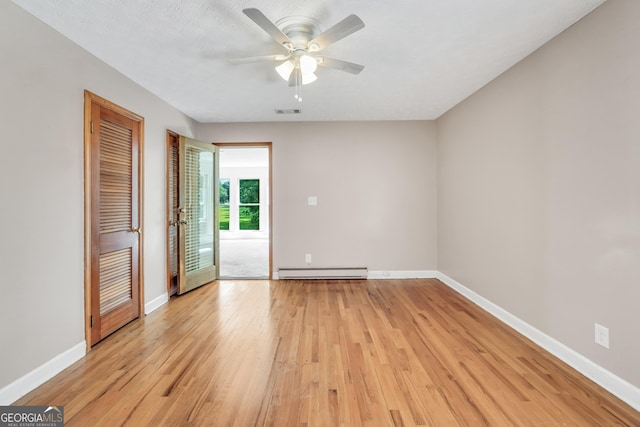 234 Crumbley Rd, Mcdonough, GA 30252 - spare room featuring baseboard heating, light wood-style floors, and ceiling fan