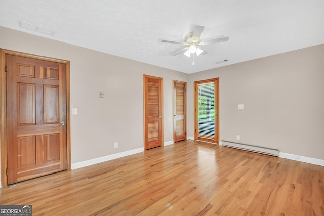 234 Crumbley Rd, Mcdonough, GA 30252 - empty room with baseboard heating, a ceiling fan, and light wood-style floors