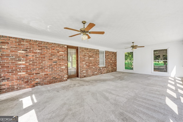 234 Crumbley Rd, Mcdonough, GA 30252 - unfurnished living room featuring brick wall, carpet floors, and a ceiling fan