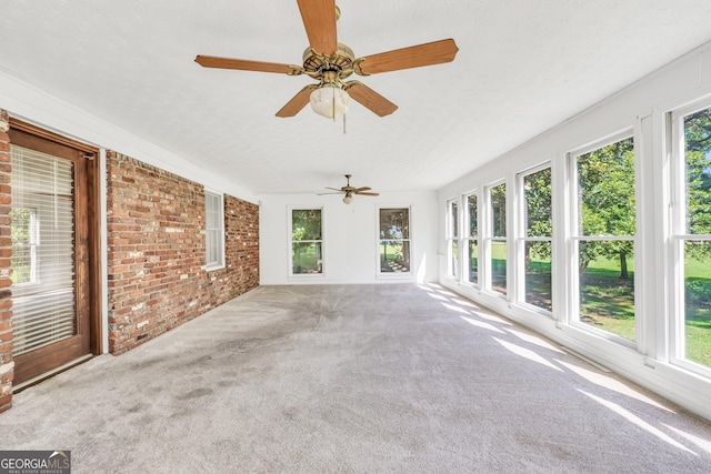 234 Crumbley Rd, Mcdonough, GA 30252 - unfurnished sunroom with brick wall and carpet
