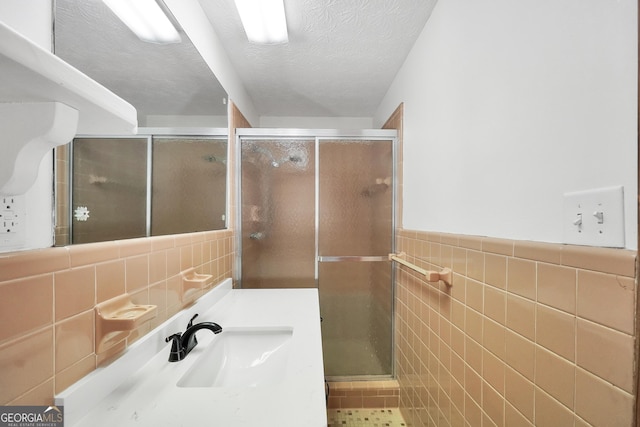 234 Crumbley Rd, Mcdonough, GA 30252 - full bath with tile walls, a textured ceiling, a stall shower, and vanity