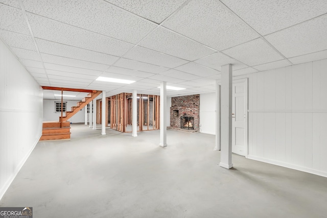 234 Crumbley Rd, Mcdonough, GA 30252 - finished basement with stairway, a brick fireplace, and a paneled ceiling