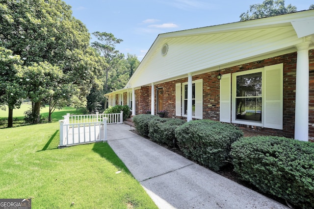 234 Crumbley Rd, Mcdonough, GA 30252 - view of side of property featuring a porch, a yard, and brick siding