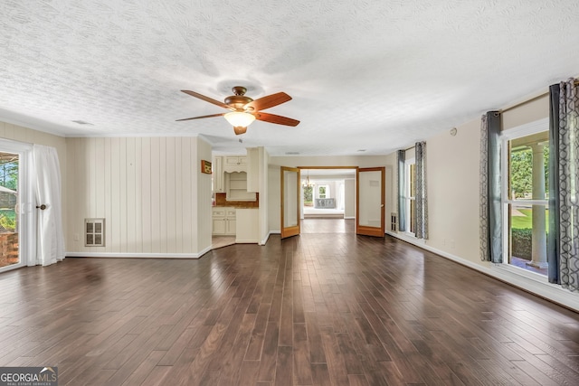 234 Crumbley Rd, Mcdonough, GA 30252 - unfurnished living room with a ceiling fan, dark wood-style flooring, a textured ceiling, and ornamental molding