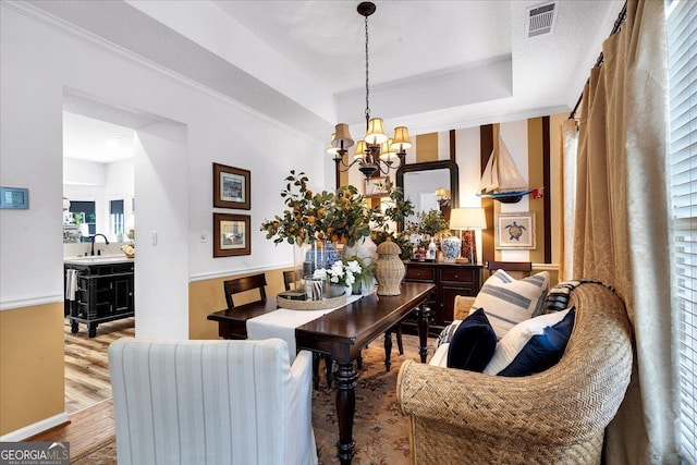 4385 Pinehollow Ct, Alpharetta, GA 30022 - living room featuring a chandelier, wood finished floors, and a tray ceiling