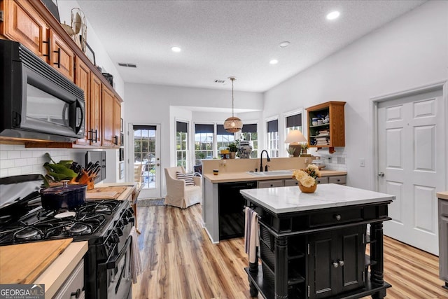 4385 Pinehollow Ct, Alpharetta, GA 30022 - kitchen featuring black appliances, open shelves, dark cabinets, brown cabinetry, and backsplash