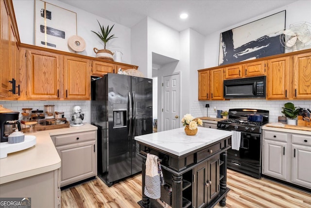 4385 Pinehollow Ct, Alpharetta, GA 30022 - kitchen with black appliances, light countertops, backsplash, and light wood-type flooring