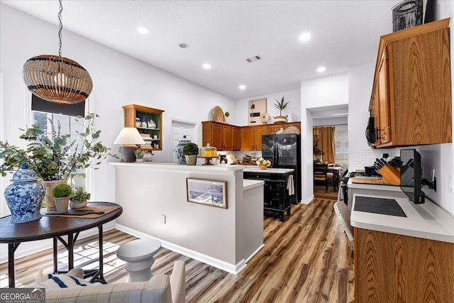 4385 Pinehollow Ct, Alpharetta, GA 30022 - kitchen featuring black appliances, brown cabinetry, light wood-style flooring, light countertops, and recessed lighting