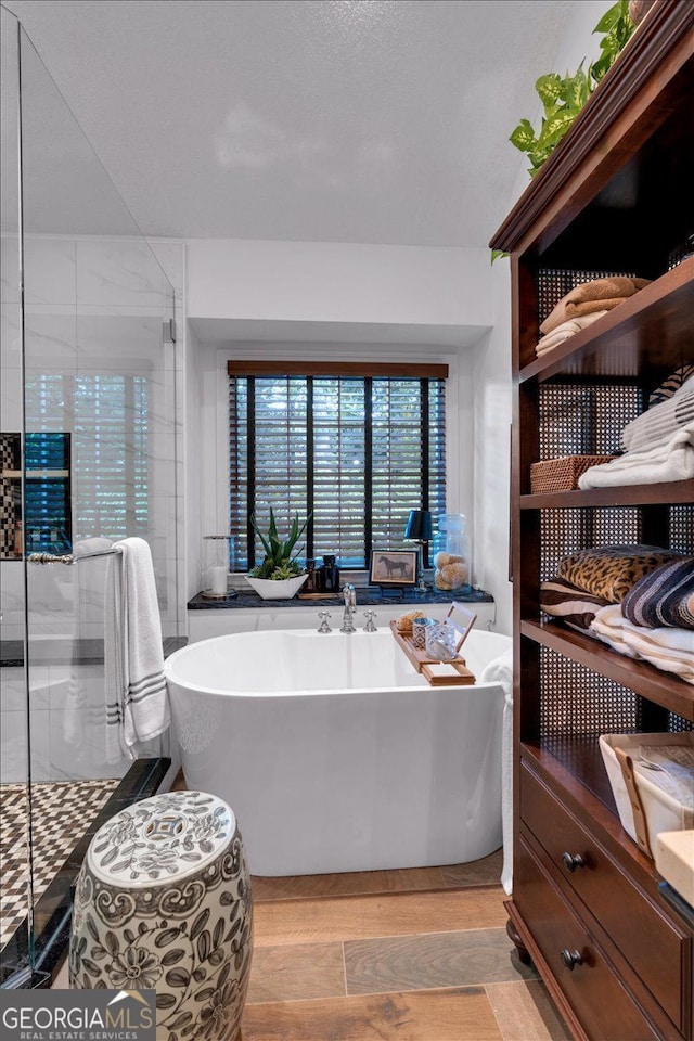 4385 Pinehollow Ct, Alpharetta, GA 30022 - full bathroom featuring a freestanding bath, a stall shower, and wood finished floors
