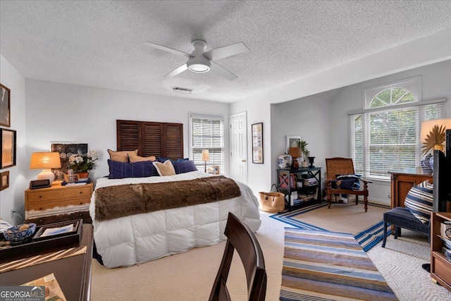 4385 Pinehollow Ct, Alpharetta, GA 30022 - bedroom with carpet floors, a textured ceiling, multiple windows, and a ceiling fan