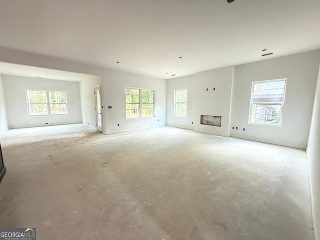 101 Everwood Ct, Dallas, GA 30132 - unfurnished living room featuring unfinished concrete flooring and a fireplace