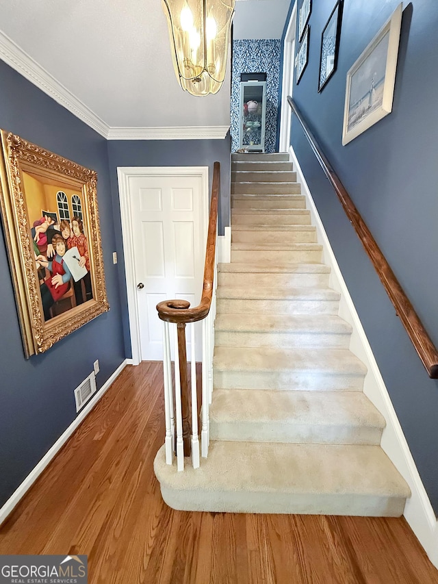 180 Broomsedge Trl, Athens, GA 30605 - staircase with a chandelier, wood finished floors, and ornamental molding