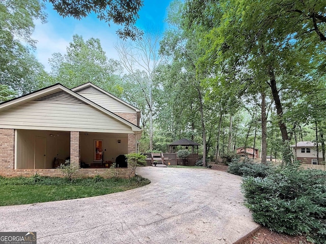 180 Broomsedge Trl, Athens, GA 30605 - view of home's exterior featuring brick siding, a gazebo, and driveway