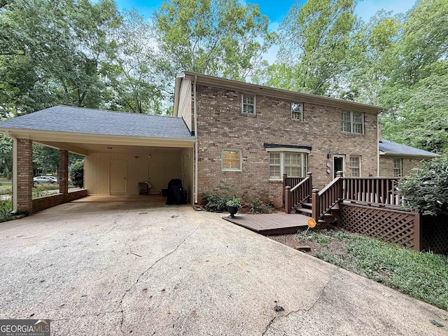 180 Broomsedge Trl, Athens, GA 30605 - rear view of house featuring asphalt driveway, a wooden deck, brick siding, and a carport