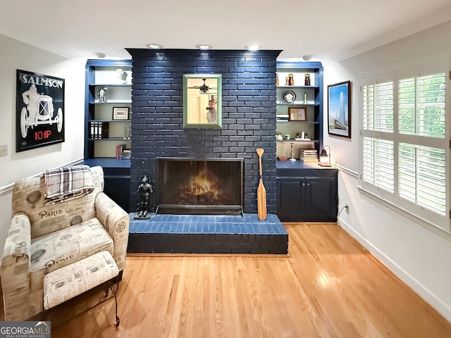 180 Broomsedge Trl, Athens, GA 30605 - living area featuring crown molding, wood finished floors, built in features, and a fireplace