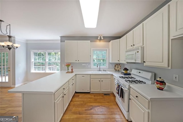 5176 Shotwell St, Woodstock, GA 30188 - kitchen featuring white appliances, light wood-type flooring, a peninsula, light countertops, and ornamental molding