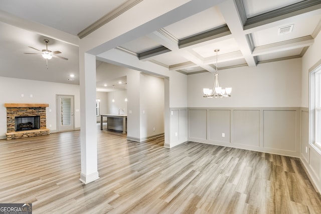 32 Sourwood Dr, Mansfield, GA 30055 - unfurnished dining area with a chandelier, beamed ceiling, light wood-style floors, ceiling fan, and a stone fireplace