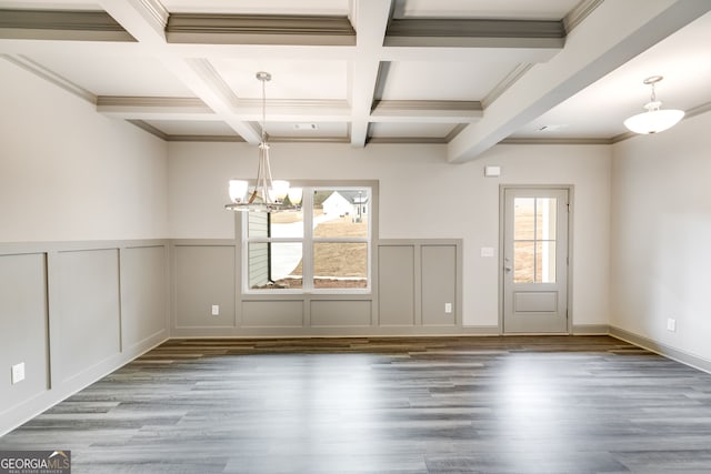 32 Sourwood Dr, Mansfield, GA 30055 - unfurnished dining area with a chandelier, beam ceiling, coffered ceiling, wood finished floors, and a decorative wall