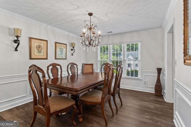 4961 Thornwood Trce NW, Acworth, GA 30102 - dining room with dark wood-type flooring, a chandelier, a decorative wall, ornamental molding, and a textured ceiling