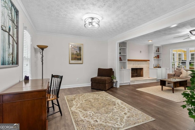 4961 Thornwood Trce NW, Acworth, GA 30102 - office space with dark wood-style floors, ornamental molding, a tiled fireplace, a textured ceiling, and a ceiling fan