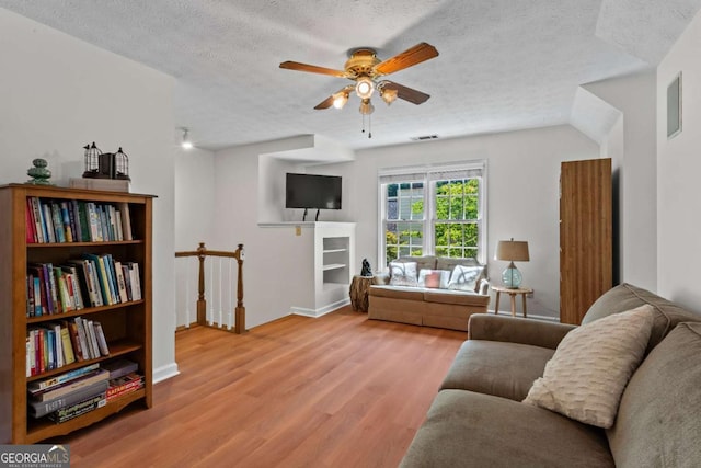 4961 Thornwood Trce NW, Acworth, GA 30102 - living room featuring a textured ceiling, ceiling fan, and wood finished floors