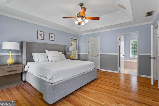 4961 Thornwood Trce NW, Acworth, GA 30102 - bedroom with a raised ceiling, wood finished floors, crown molding, a ceiling fan, and ensuite bath