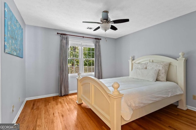4961 Thornwood Trce NW, Acworth, GA 30102 - bedroom featuring wood finished floors, a ceiling fan, and a textured ceiling