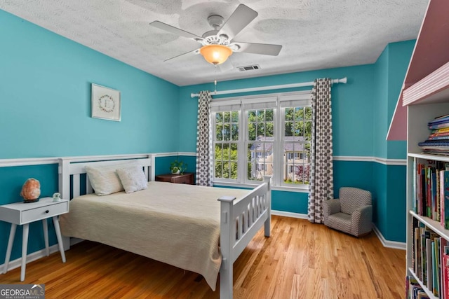 4961 Thornwood Trce NW, Acworth, GA 30102 - bedroom with wood finished floors, a textured ceiling, and a ceiling fan