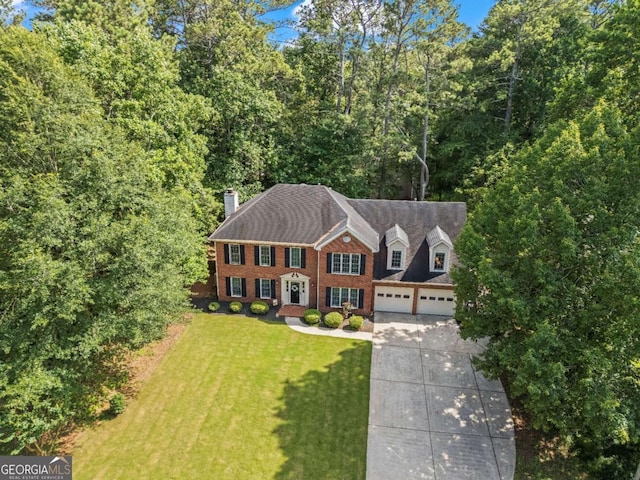 4961 Thornwood Trce NW, Acworth, GA 30102 - view of front of property featuring concrete driveway, a chimney, a front yard, and brick siding