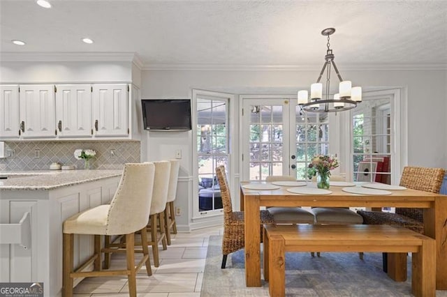 7045 Hunters Knl NE, Sandy Springs, GA 30328 - dining room with a chandelier, plenty of natural light, recessed lighting, light tile patterned floors, and crown molding