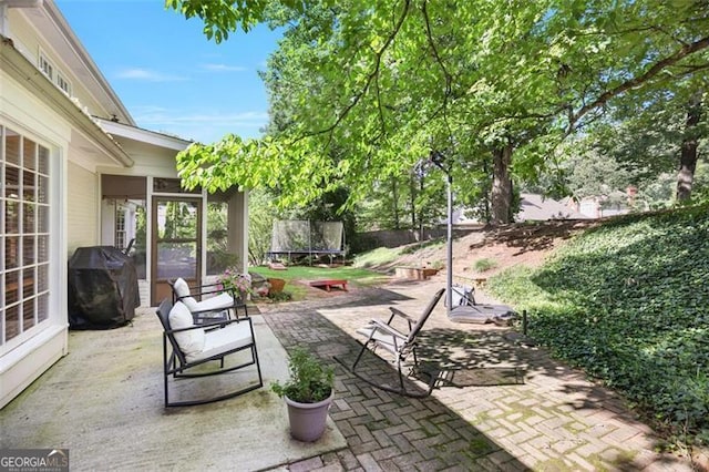 7045 Hunters Knl NE, Sandy Springs, GA 30328 - view of patio / terrace with a trampoline, a grill, and a sunroom